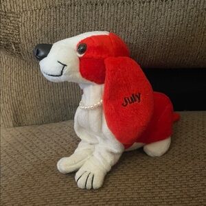 Red and white “July” stuffed dog